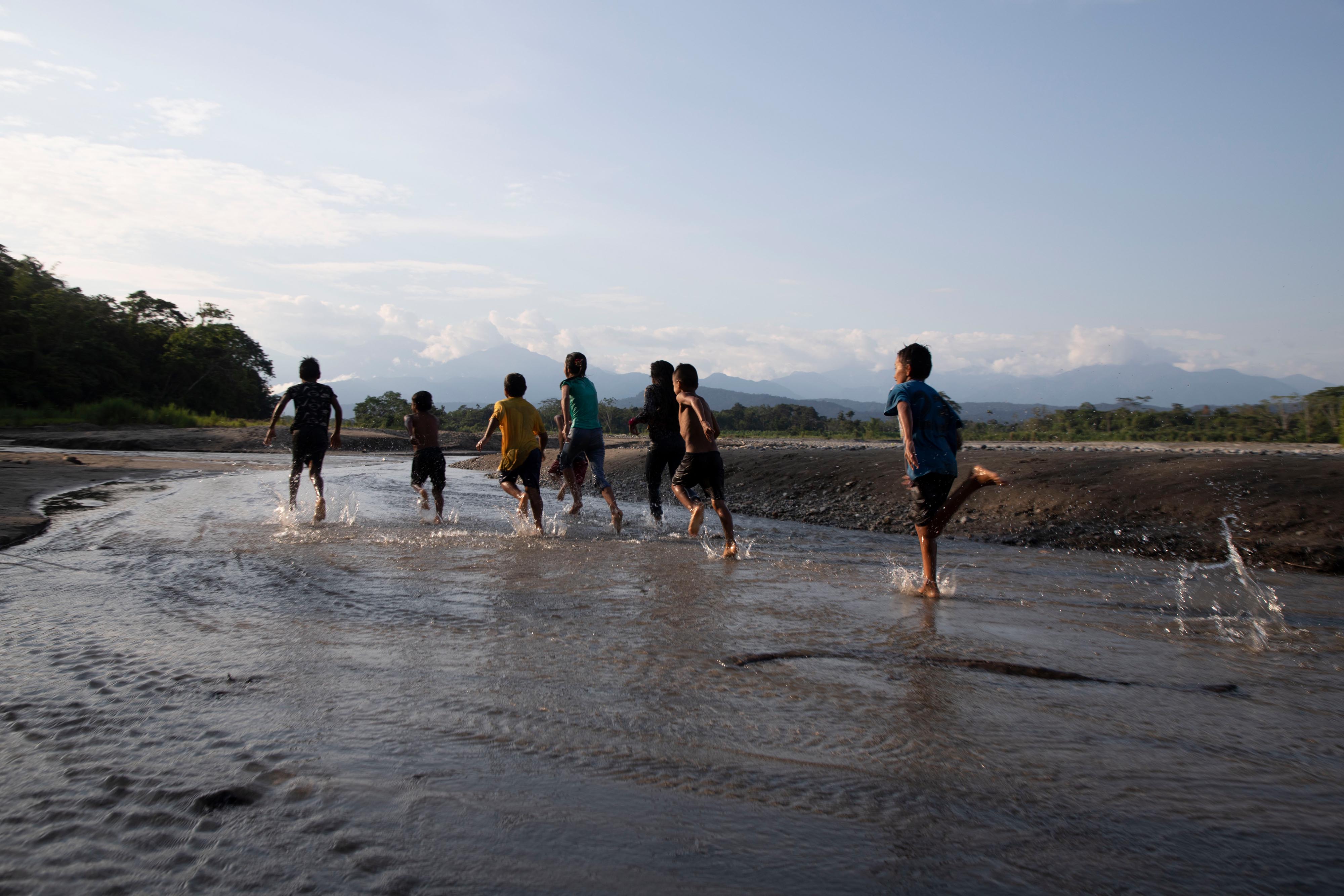 Children running along the beach.
